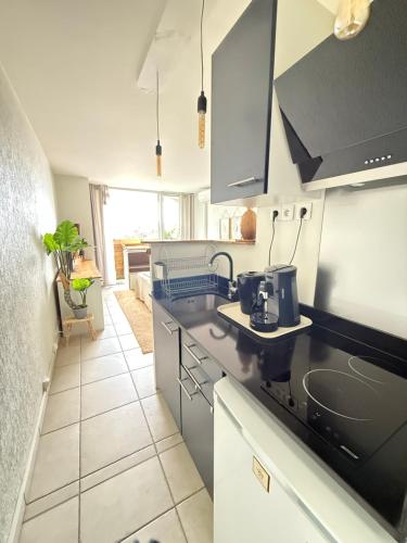 a kitchen with a sink and a counter top at Tropi-k in Le Gosier