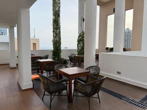 a restaurant with tables and chairs and windows at Stylish Apartment in Colombo in Colombo