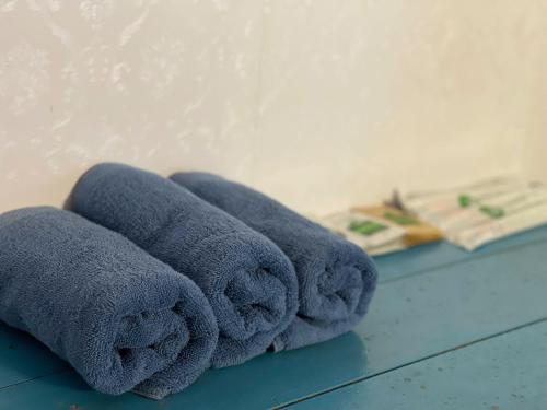 a pile of towels sitting on a table at Homestay Quan Lan - BLUE by MAY5 in Quan Lạn