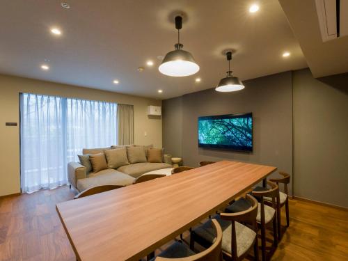 a living room with a couch and a table at Rakuten STAY VILLA Hakone Togendai in Hakone