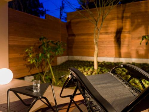 a chair sitting on a patio with a table at Rakuten STAY VILLA Hakone Togendai in Hakone