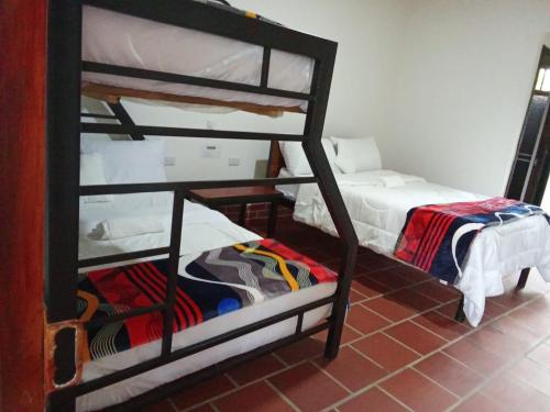 Postel nebo postele na pokoji v ubytování Curitagua Hotel Campestre