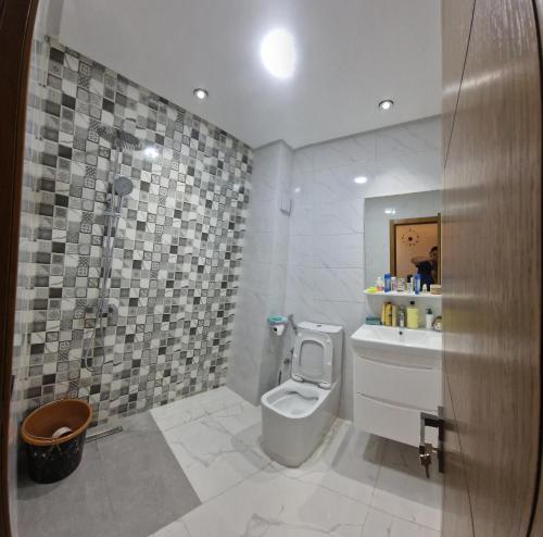 a bathroom with a toilet and a sink at Escale calme et moderne in Oulad Akkou