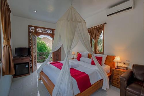 a bedroom with a bed with a mosquito net at Sekarinis Place in Amed
