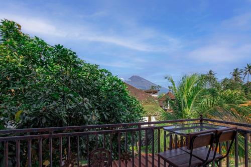 a balcony with a table and some trees at Sekarinis Place in Amed