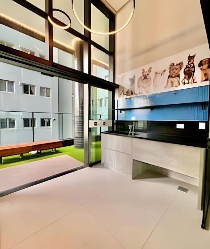 an open living room with a bench and a large window at #The RED# C/PiSciNa, Ar Cond & Garagem in Curitiba
