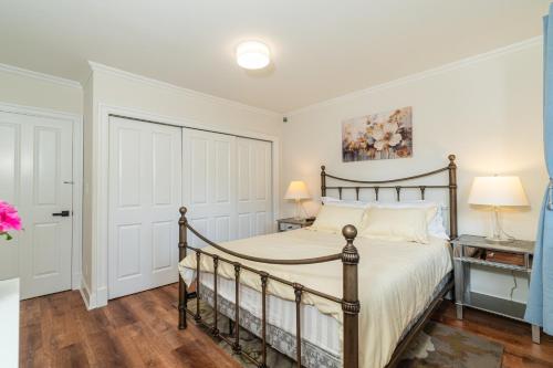 a bedroom with a bed with a wooden frame at 7811 The Solace Vista in Vancouver