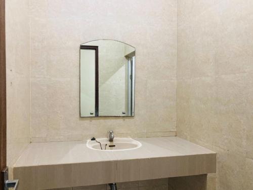 a bathroom with a sink and a mirror at RedDoorz near Jalan Malioboro Area in Ngabean