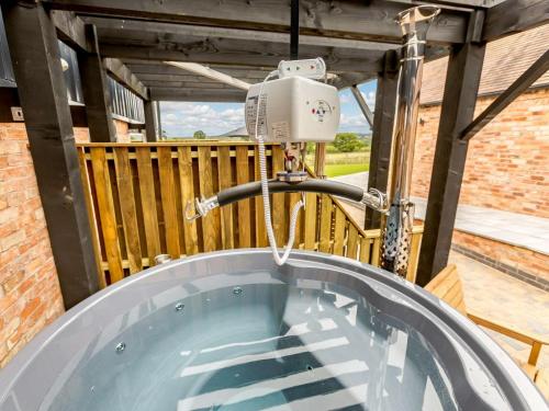 a jacuzzi tub in a garden with a water fountain at 2 Bed in Alcester 88397 in Coughton