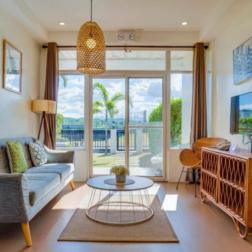 a living room with a couch and a table at The Mansion Boutique Hotel in Mabalacat