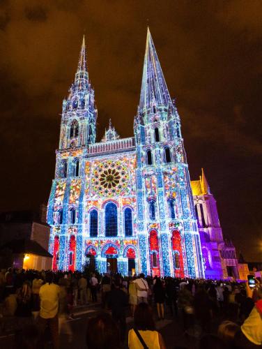 a large building with christmas lights on it at Novotel Chartres in Chartres