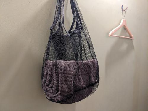 a bag hanging on a wall on a hook at Tomarotto Hostel in Takayama
