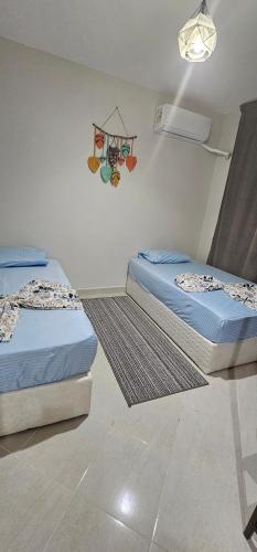 two beds in a room with at بيت الروبي in Ain Sokhna