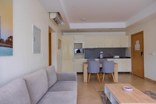 a living room with a couch and a table at CasaNova Airport Suites in Accra