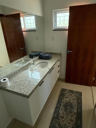 ein Badezimmer mit Waschbecken und Spiegel in der Unterkunft Malicia Ranch in Lagoa do Boi