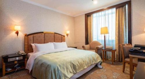a hotel room with a large bed and a window at Quanzhou Royal Prince Hotel in Quanzhou