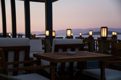 a table and chairs on the roof of a restaurant at Samara Hotel Bodrum Ultra All Inclusive in Torba