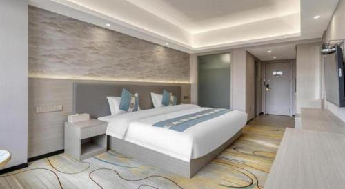 a bedroom with a large bed in a room at Lijiang Waika Hotel in Lijiang