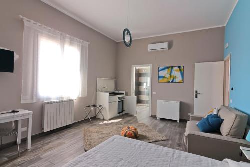 a living room with a bed and a couch at Le Cupole Design in Palermo