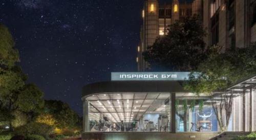 a building with a sign on top of it at night at Tongxiang Inspirock Hotel in Jiaxing