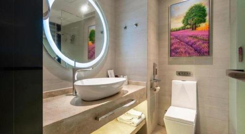a bathroom with a sink and a large mirror at Lavande Hotel Wuhan Jianghan Road Subway Station in Wuhan