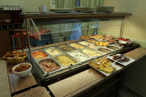 a buffet line with many different types of food at Hotel Restaurant De La Roche in Les Sauvages