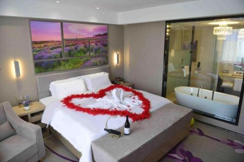 a bedroom with a bed and a bath tub at Lavande Hotels Changzhi City God Temple in Changzhi