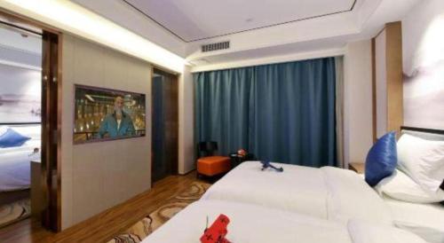 a hotel room with two beds and a large window at East Queen Hotel (Xi'an Beimen Metro Station) in Xi'an