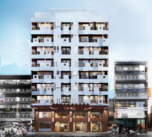 a tall white building with balconies on it at Urbanli Hatyai Hotel in Hat Yai