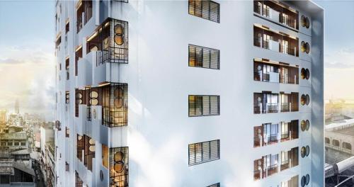 a facade of a building with windows at Urbanli Hatyai Hotel in Hat Yai