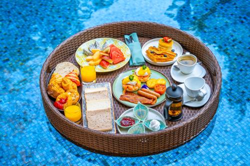 a miniature table with breakfast foods and drinks on it at SO/ Sofitel Hua Hin in Cha Am