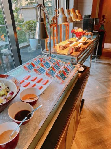 a buffet line with many different types of food at Holiday Inn Shanghai Hongqiao by IHG - near by Hongqiao Airport & NECC in Shanghai