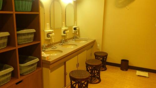 a bathroom with two sinks and two stools at Daibutsukan in Nara