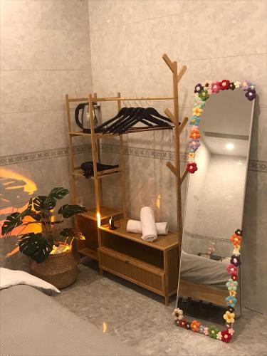 a bathroom with a mirror and a shelf with towels at DU Home Huế in Thôn An Hòa