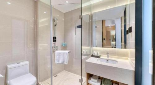 a bathroom with a toilet and a sink and a shower at City Comfort Inn Lijiang Ancient Town in Lijiang