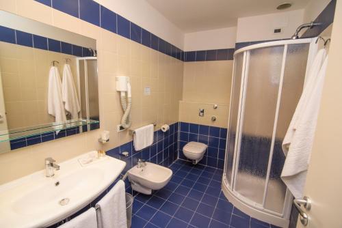 a bathroom with a sink and a toilet and a shower at Grand Hotel President in Siderno Marina