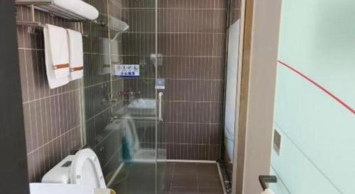 a bathroom with a shower with a toilet and a sink at Thank Inn Plus Hotel Guangdong Yunfu Luoding City Municipal in Yunfu