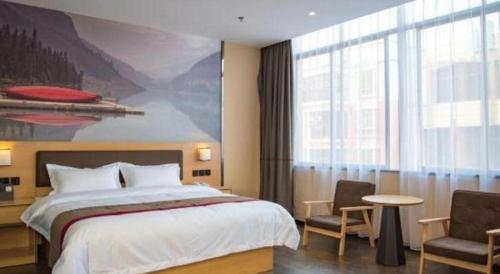 a bedroom with a large bed and a large window at Thank Inn Plus Hotel Guangdong Yunfu Luoding City Municipal in Yunfu