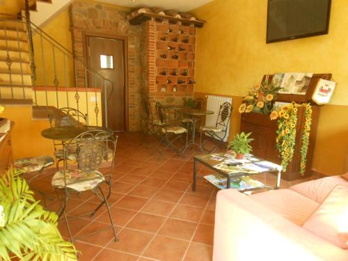 a living room with a couch and a table and chairs at B&B La Corte in Capannori