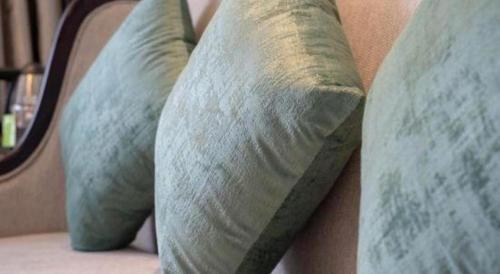 two pillows sitting on a bed in a room at GreenTree Inn Anqing Yingbin Dong Road High-Speed Railway Station in Anqing