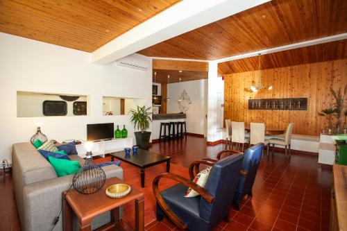 a living room with a couch and a table at Casa Senhora da Rosa in Ponta Delgada