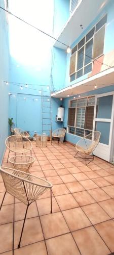 a patio with chairs and a staircase on a building at Casa de huéspedes Chukum in Mexico City