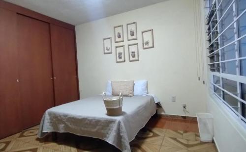 a bedroom with a bed with a basket on it at Casa de huéspedes Chukum in Mexico City