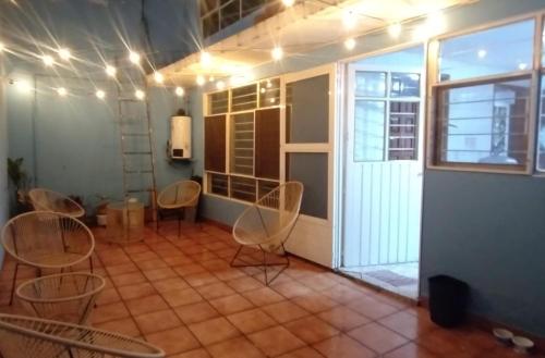 a room with chairs and a table and a window at Casa de huéspedes Chukum in Mexico City