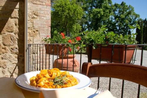 a plate of pasta on a table on a patio at Casale San Galgano in Chiusdino