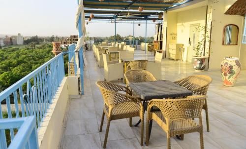 a patio with tables and chairs on a balcony at Flamingo Boutique hotels in Luxor