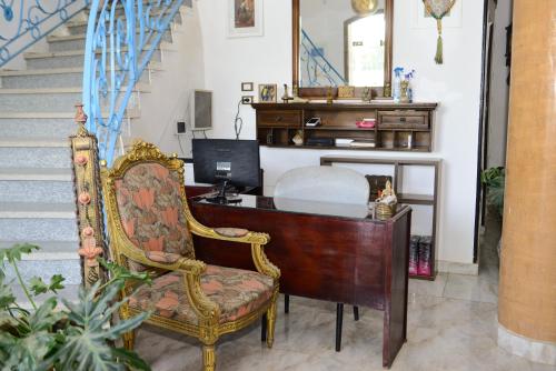 an office with a desk with a computer and a chair at Flamingo Boutique hotels in Luxor