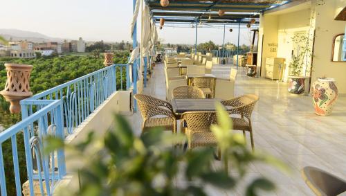 a patio with tables and chairs on a balcony at Flamingo Boutique hotels in Luxor