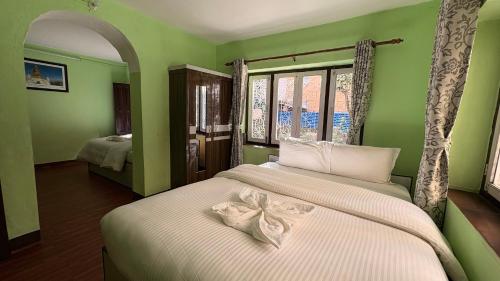 a bedroom with two beds with a bow on them at Trekking Lodge Nepal in Kathmandu