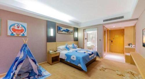 a bedroom with a blue bed and a tent at Vienna Hotel Guangdong Zhongshan Xiaolan High-Speed Railway Station in Zhongshan